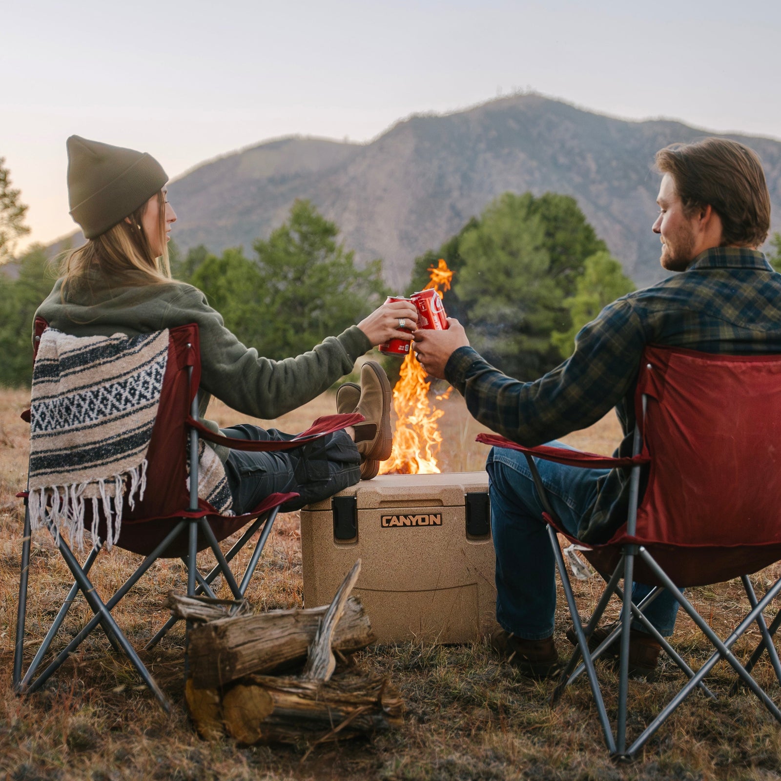 Two people at a mountain campsite with an Outfitter 35 V2 in Sandstone