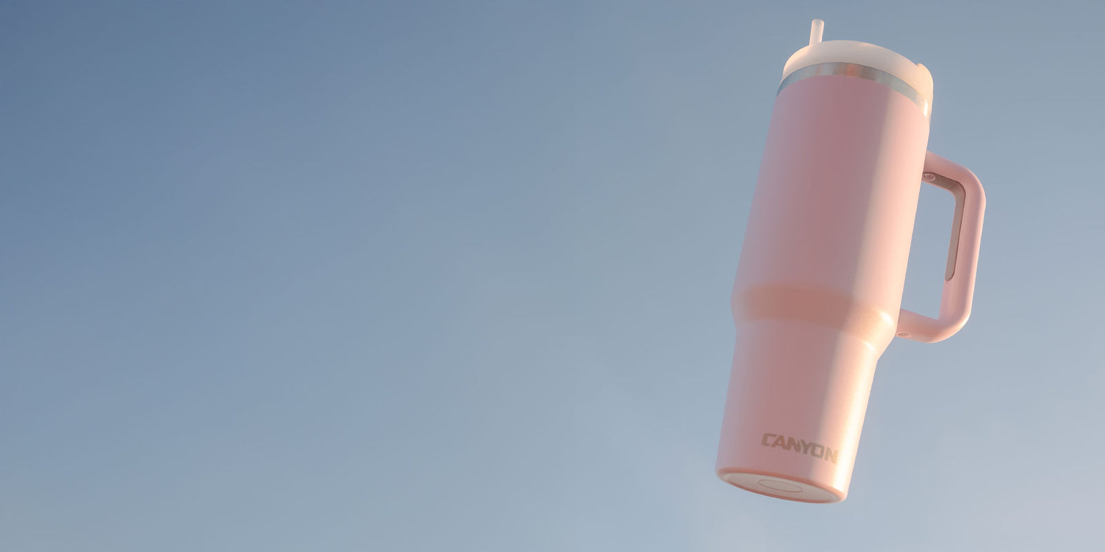 Handle Tumbler with a blue sky background