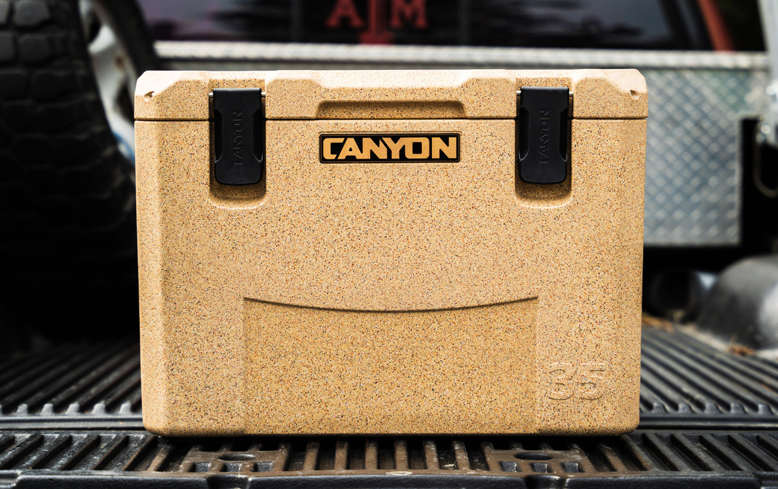 Outfitter 35 V2 Sandstone sitting on a truck bed