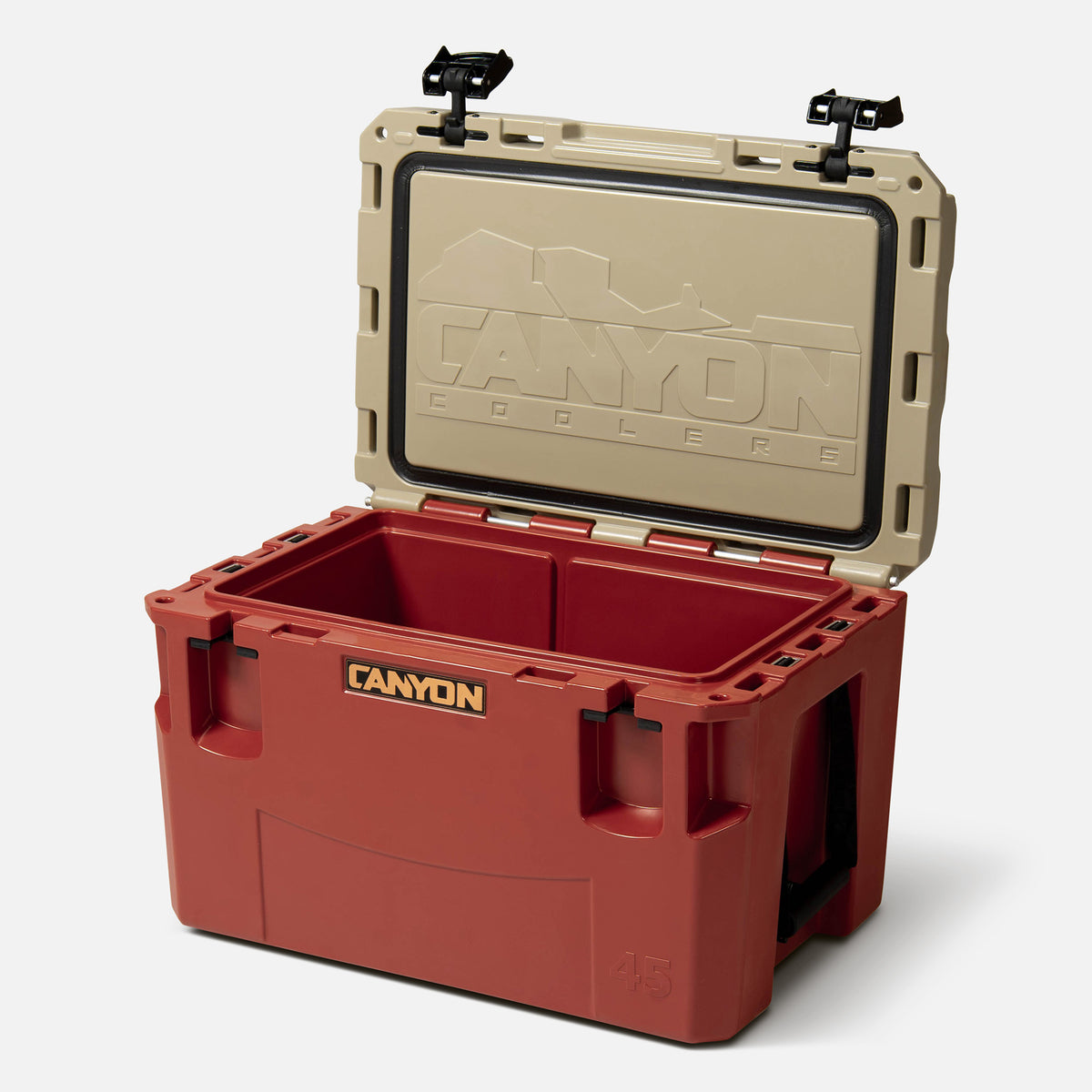 red with a tan lid 45qt medium rotomolded hard cooler offset lid open with black large handle latches and the &#39;canyon&#39; brand logo on the front. one strap handle visible, divider table visible in divider slot