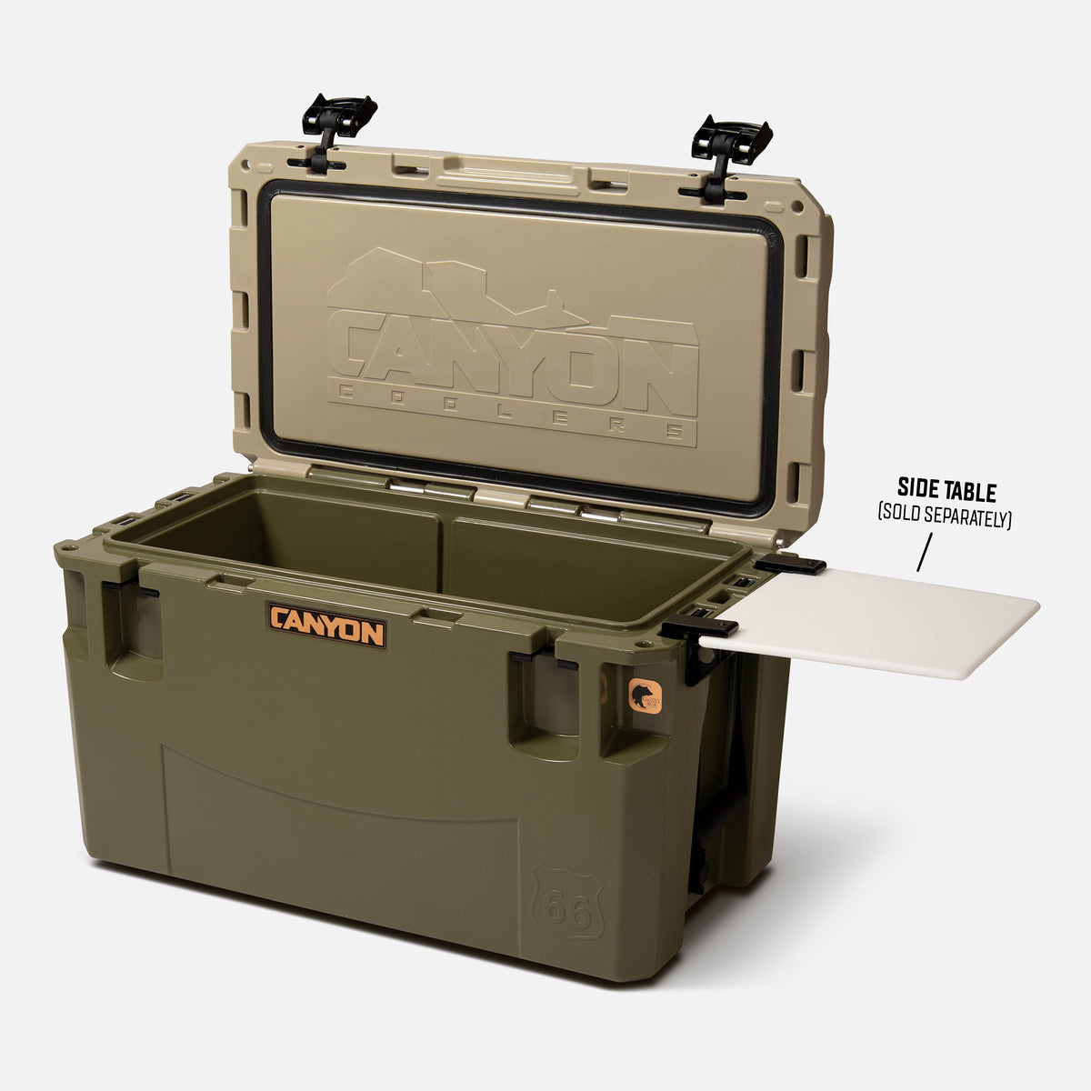 green with a tan lid  66qt large rotomolded hard cooler offset lid open with black large handle latches and the &#39;canyon&#39; brand logo on the front. one strap handle visible, divider table visible in in the table slot