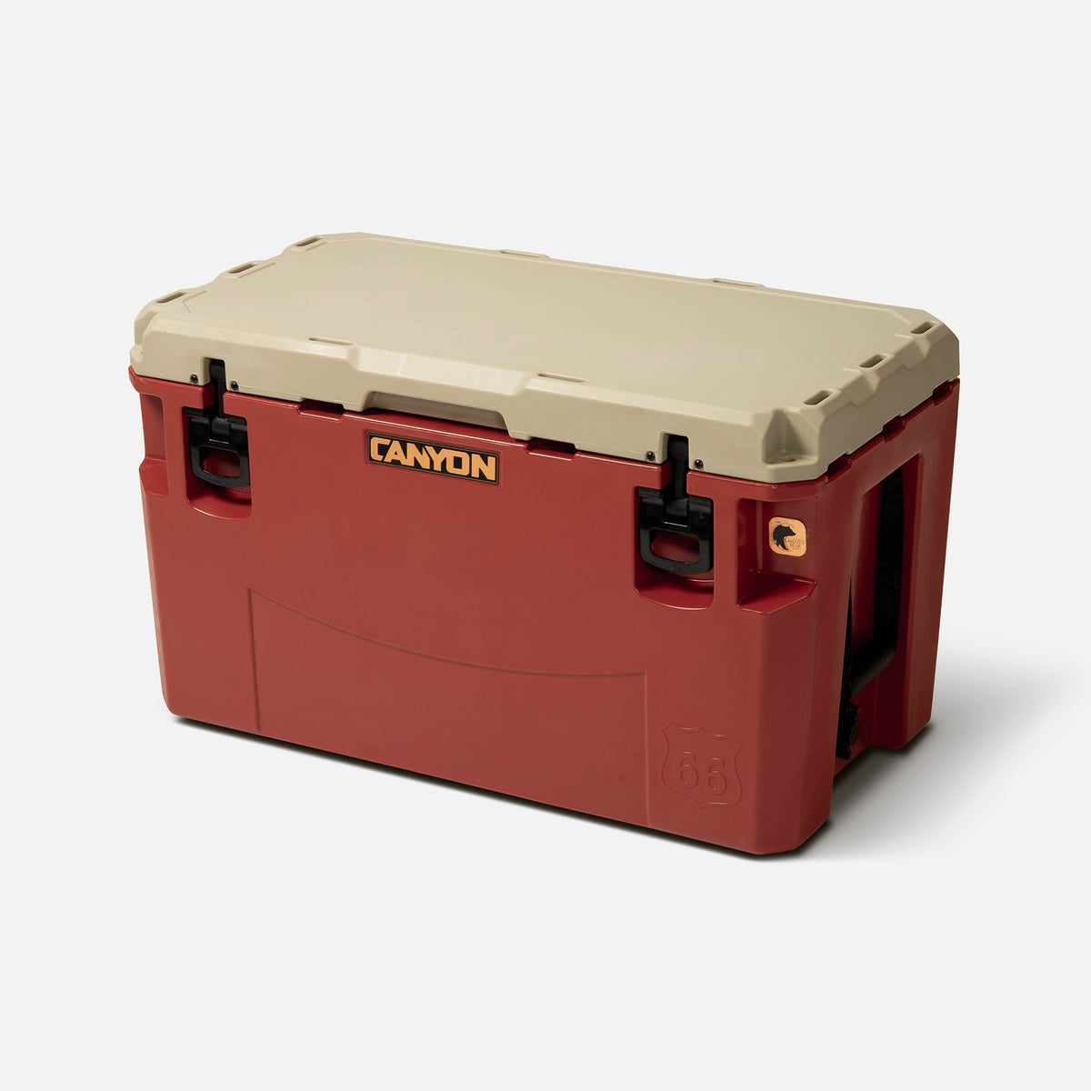 red with a tan lid 66qt large rotomolded hard cooler offset lid closed with large black latches and the &#39;canyon&#39; brand logo on the top front. strap handle on a white background