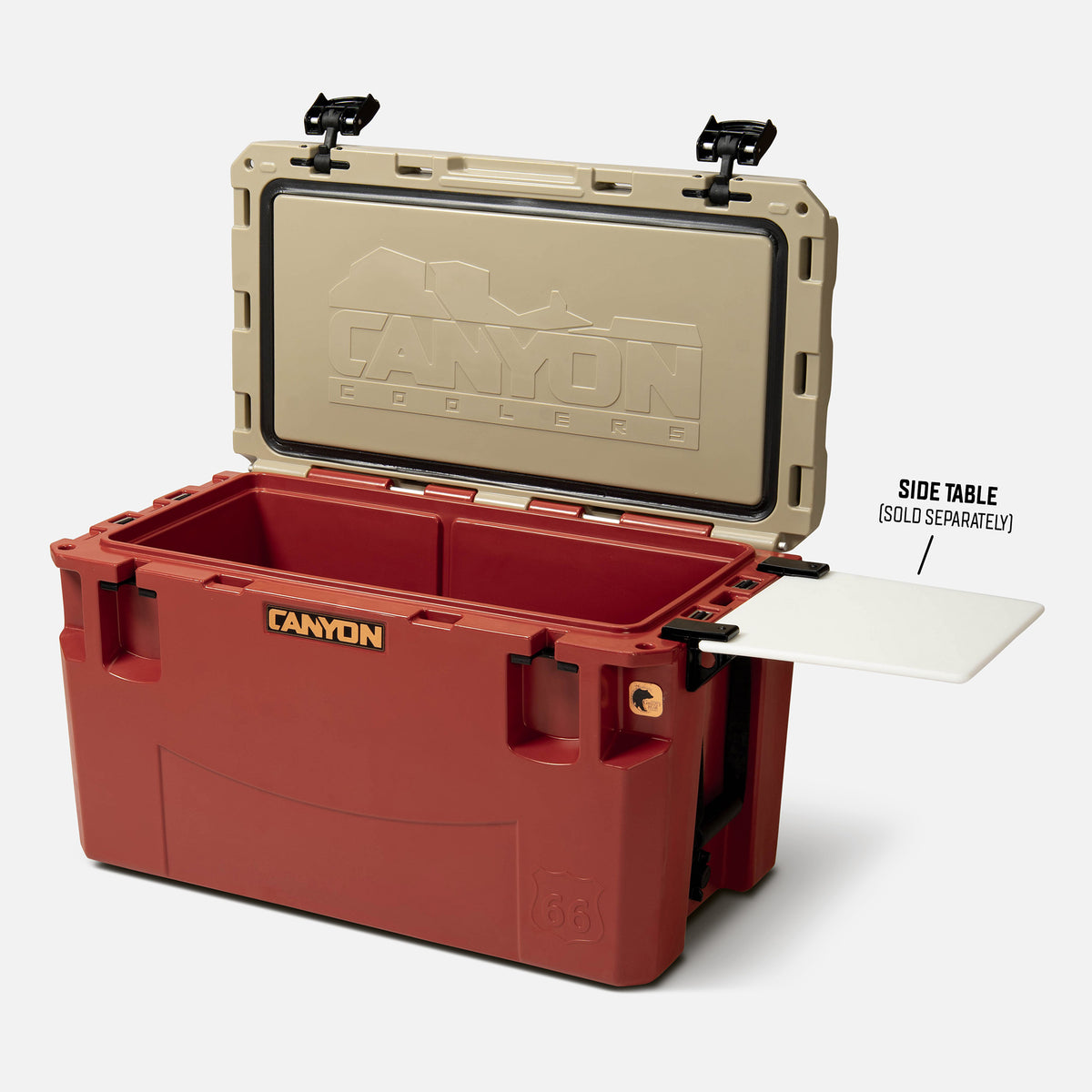 red with a tan lid 66qt large rotomolded hard cooler offset lid open with black large handle latches and the &#39;canyon&#39; brand logo on the front. one strap handle visible, divider table visible in in the table slot