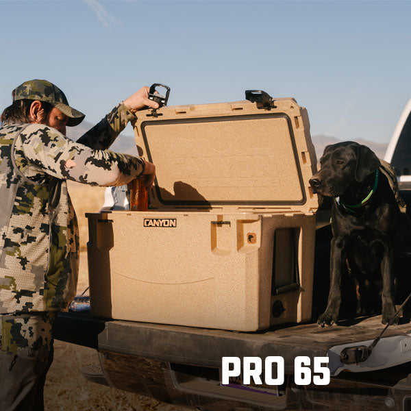 Hunter reaching into a Pro 65 Stone in the bed of his truck