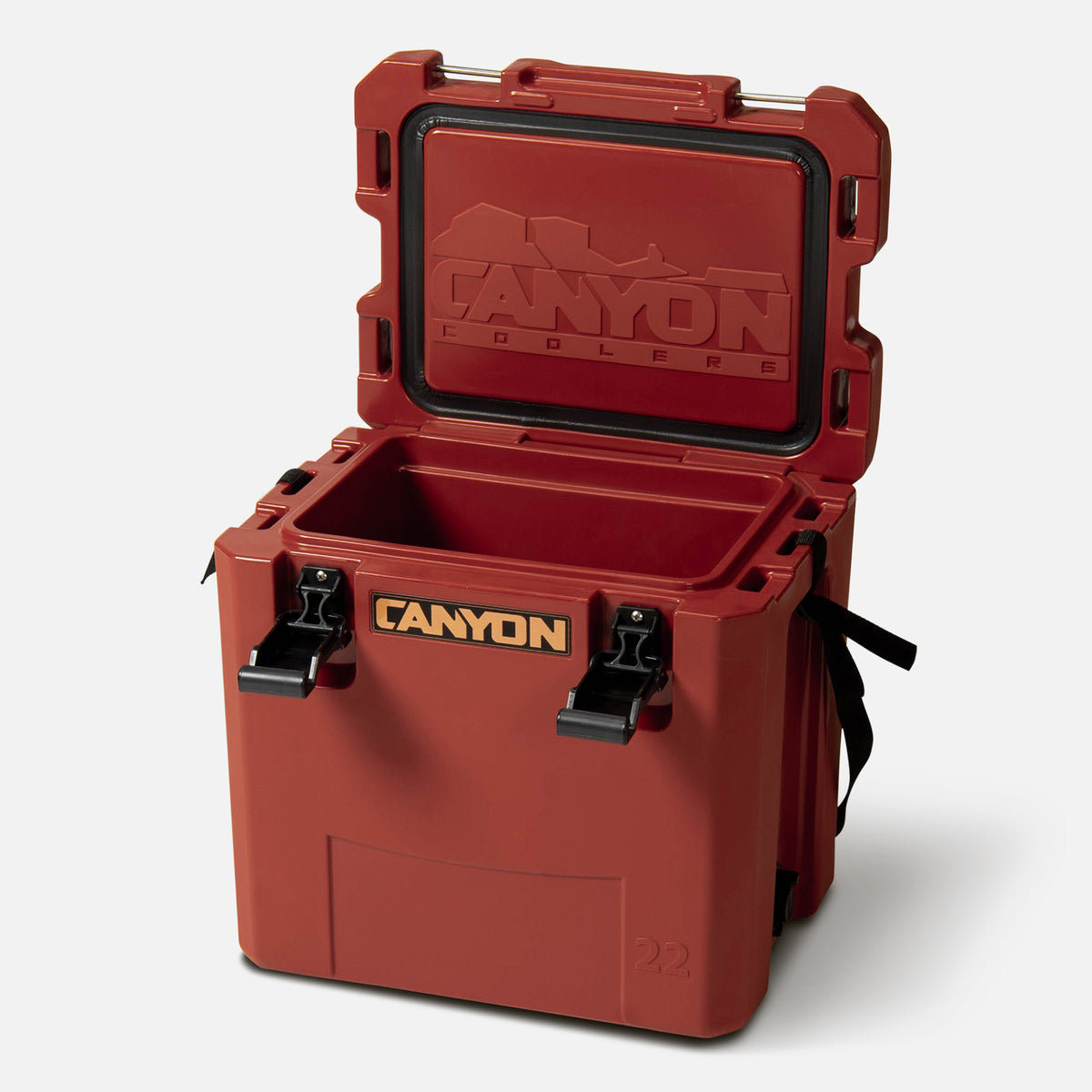 red 22qt small  hard cooler box offset facing lid open with copper colored Canyon logo on a white background cam action latch soft web handle