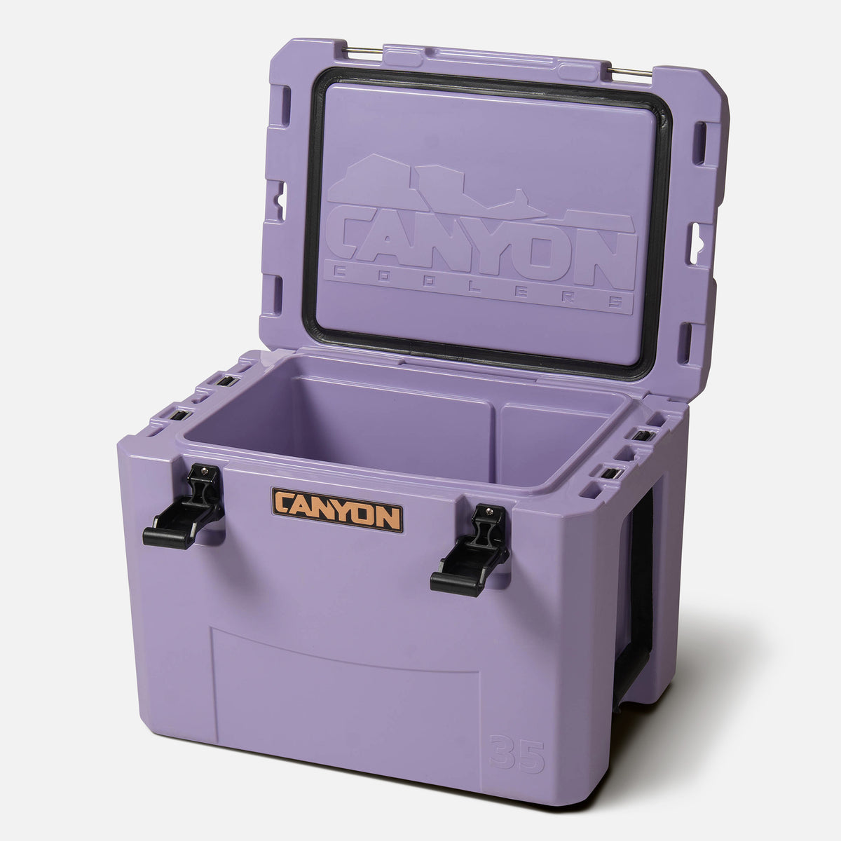 Purple 35qt medium rotomolded hard cooler offset lid open with black latches and the &#39;canyon&#39; brand logo on the front. strap handle 