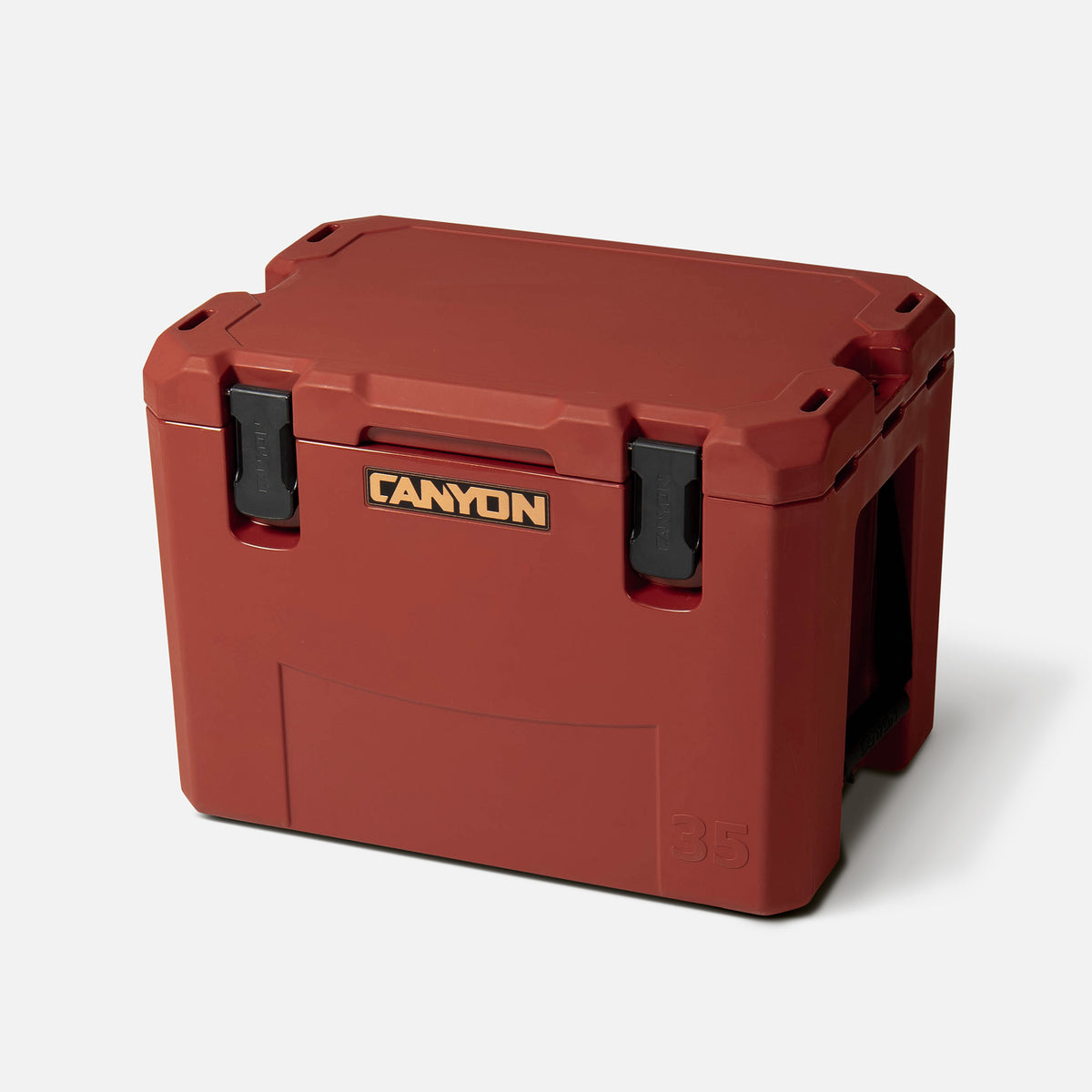 Red 35qt medium rotomolded hard cooler offset lid closed with black latches and the canyon brand logo on the top front. strap handle