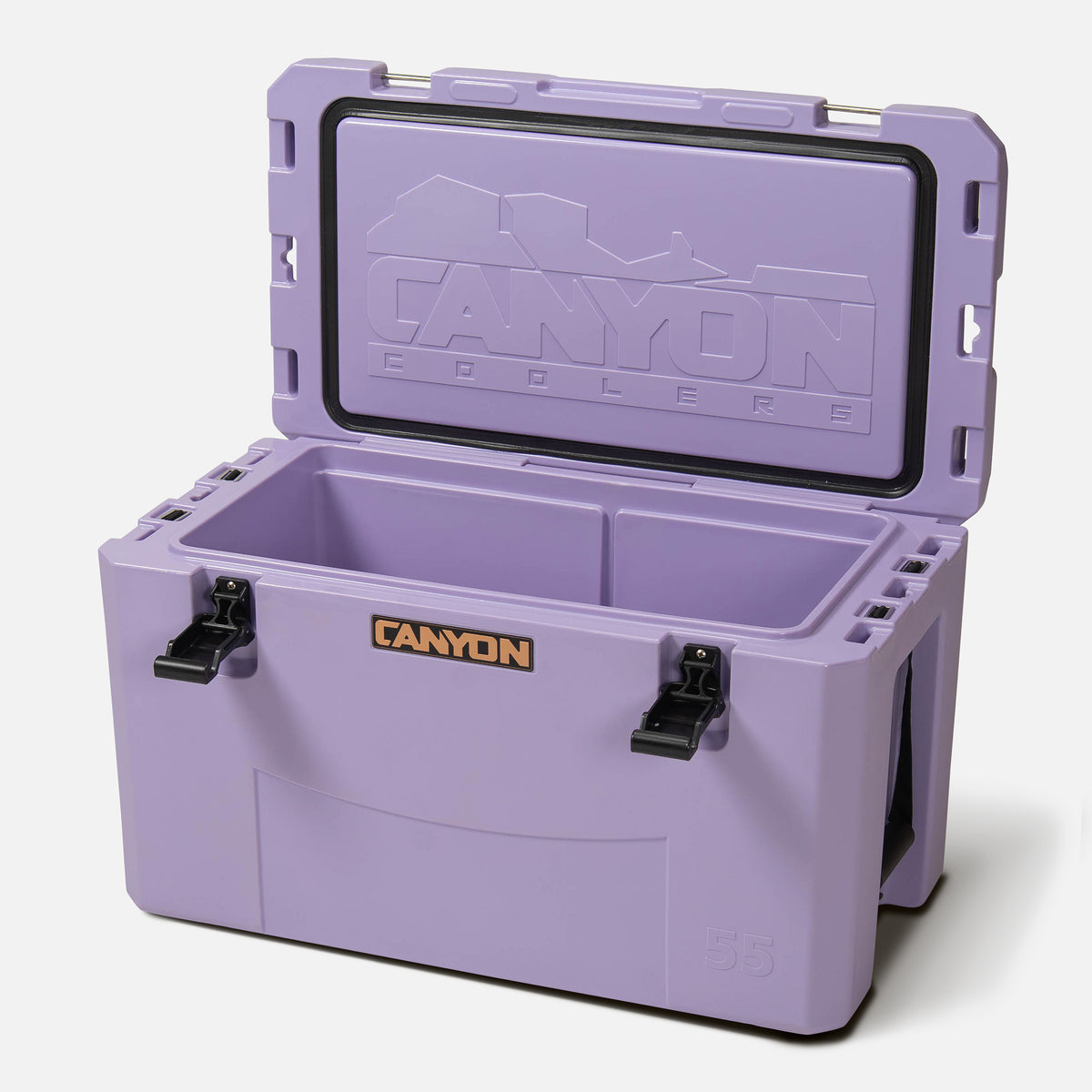 purple 55qt medium rotomolded plastic hard cooler with the brand &#39;canyon&#39; logo on the front. It has black cam latches, a textured surface. offset and open on a white background