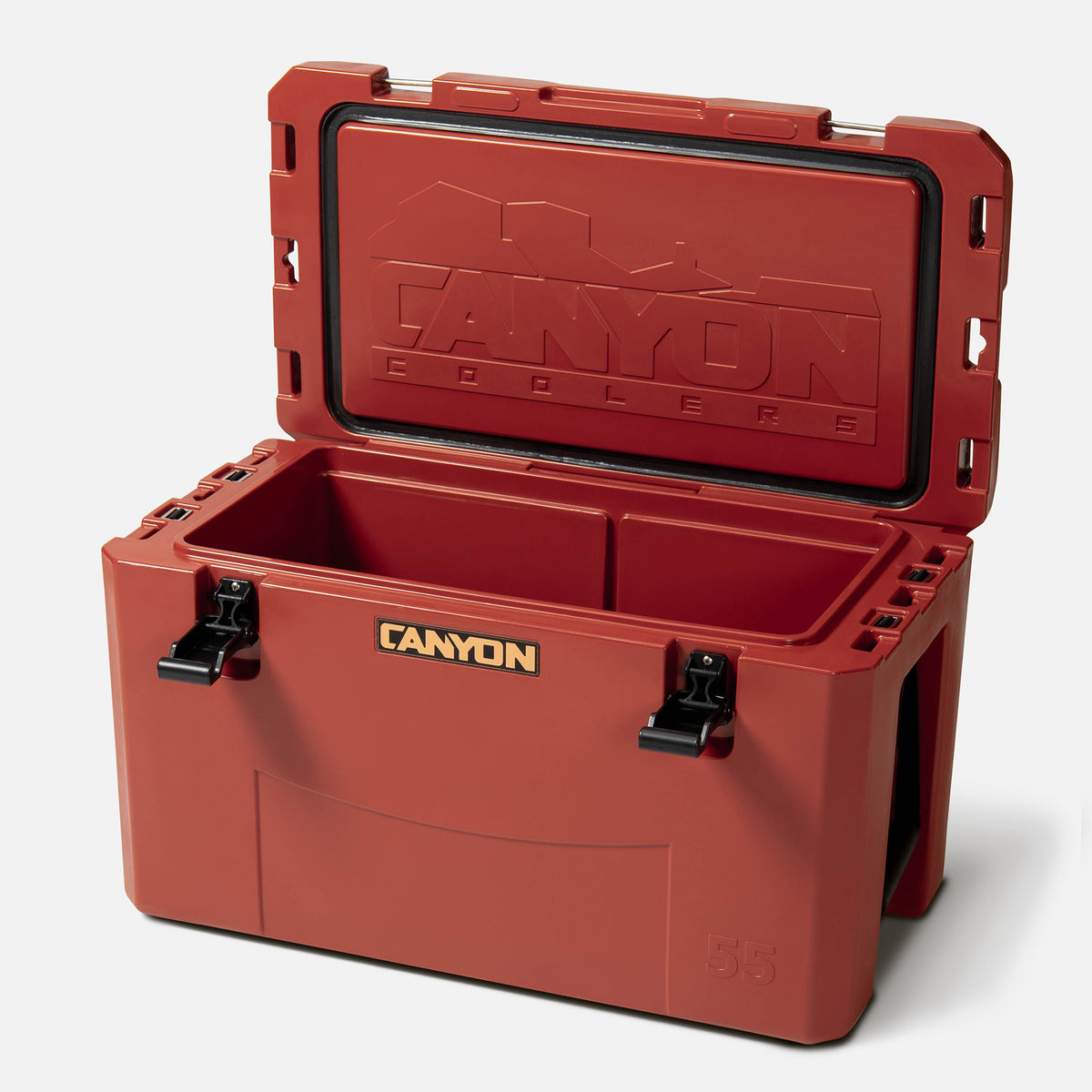 red 55qt medium rotomolded plastic hard cooler with the brand &#39;canyon&#39; logo on the front. It has black cam latches, a textured surface. offset and open on a white background